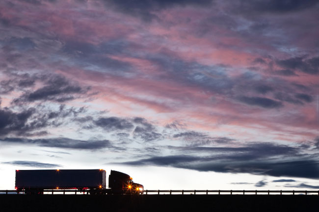 Silhouette of Commercial Truck on Highway at Dusk