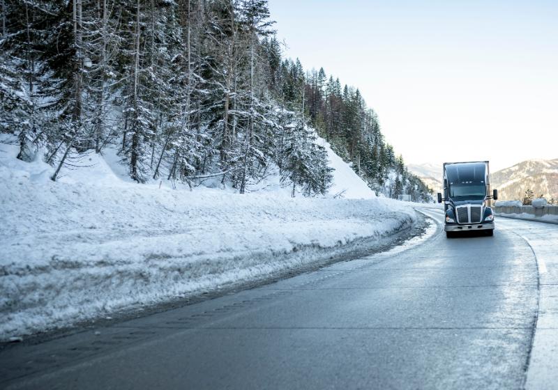 Semi-Truck Rounding Winter Snow Road