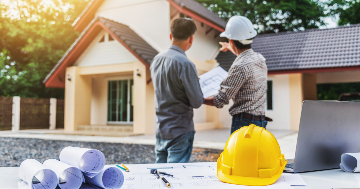 Contractor looking at house and discussing remodel project with owner