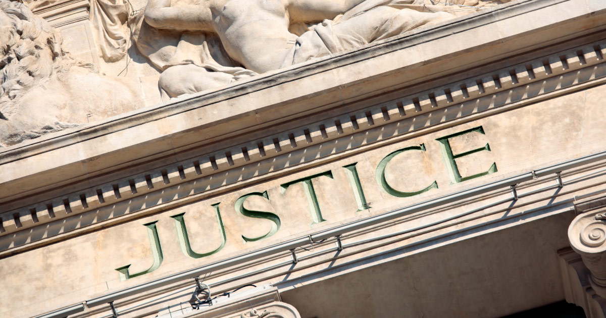 Justice etched into stone above court entrance