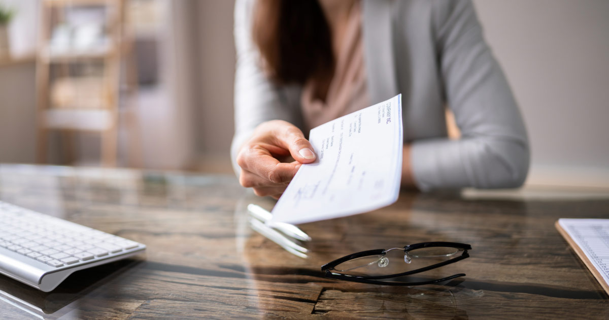 Woman handing a check over to client