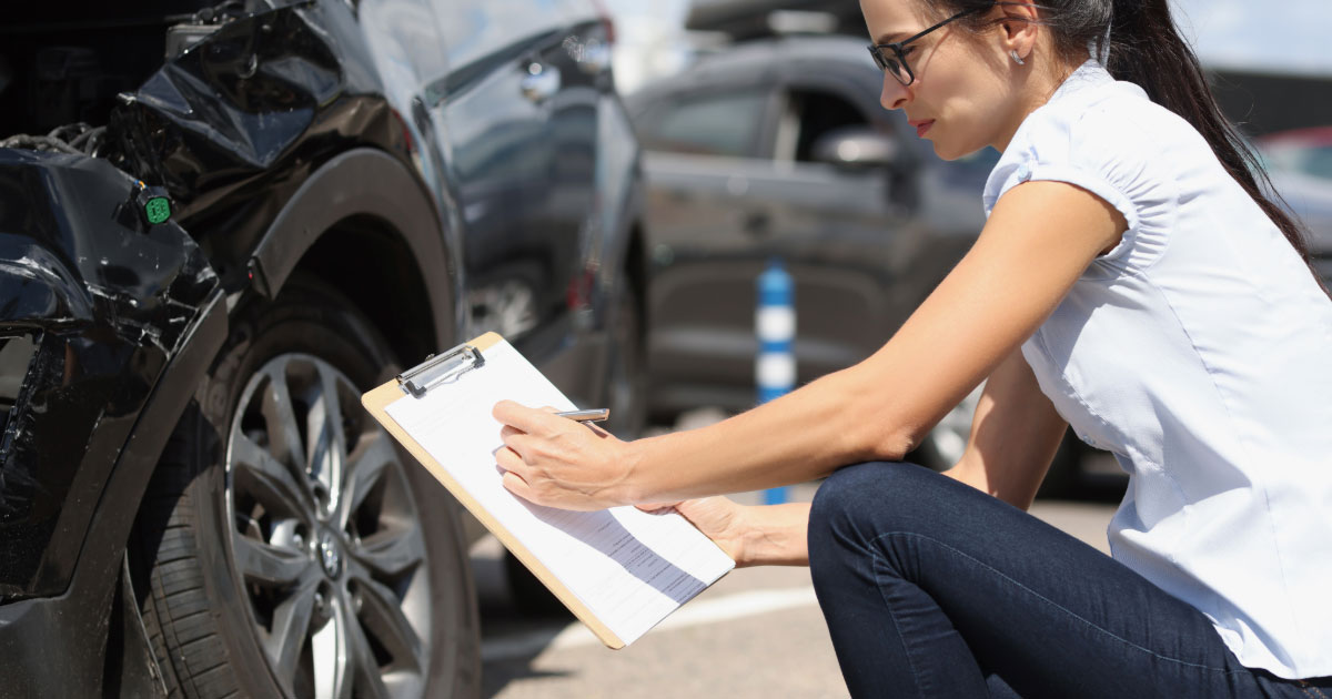 Woman conducting car accident investigation