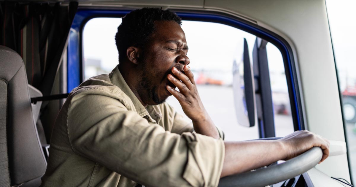 Truck driver yawning after driving for too long