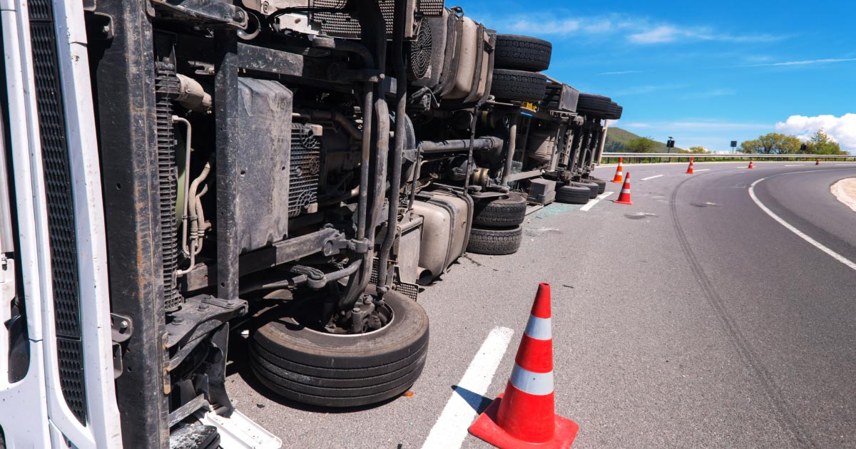 Overturned tractor-trailer truck on highway