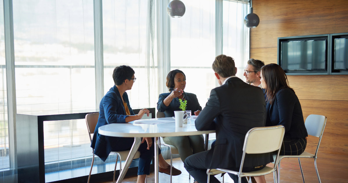Group of legal professionals sitting around a table having a meeting