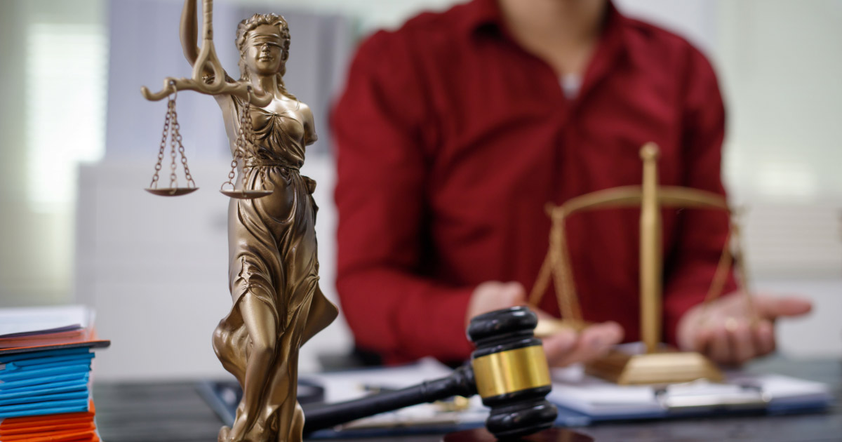 Woman speaking to lawyer in his law office