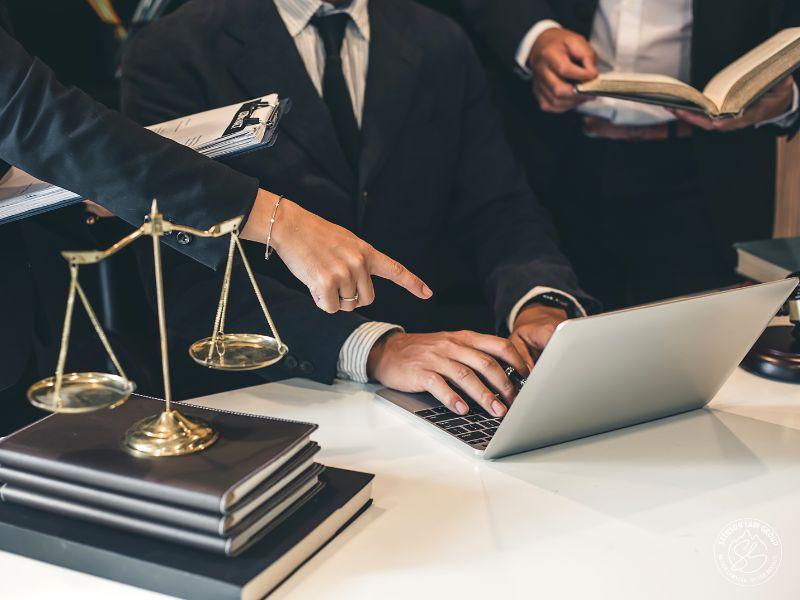 Insurance dispute lawyers reviewing documents on a laptop