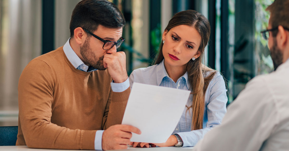 Couple reviewing paperwork with legal professional