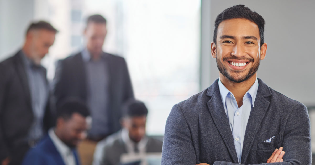 Man standing confidently in a room full of legal advisors