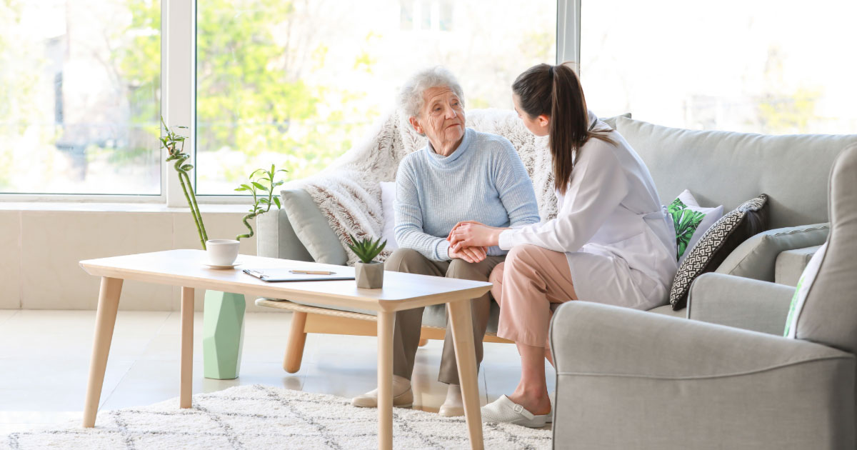 Elderly woman speaking with doctor at her nursing home facility