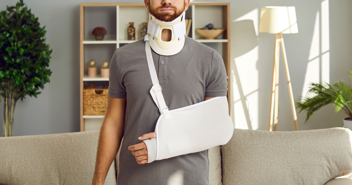 Man wearing cast on arm and neck brace after being in accident