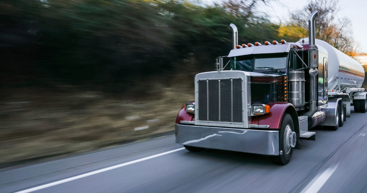 Tanker truck driving down highway road